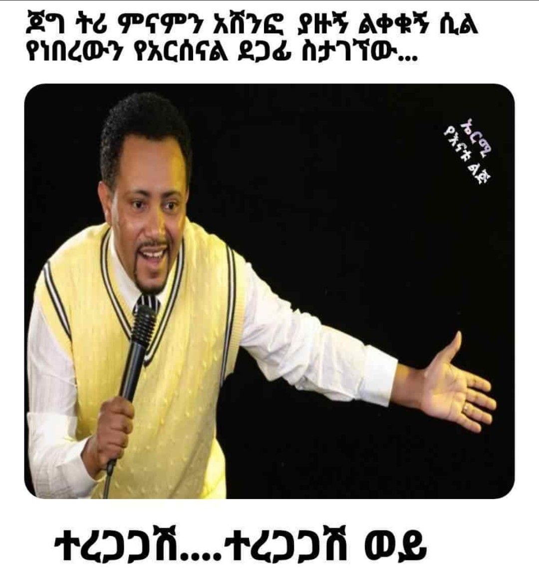 a man in a yellow vest holding a microphone